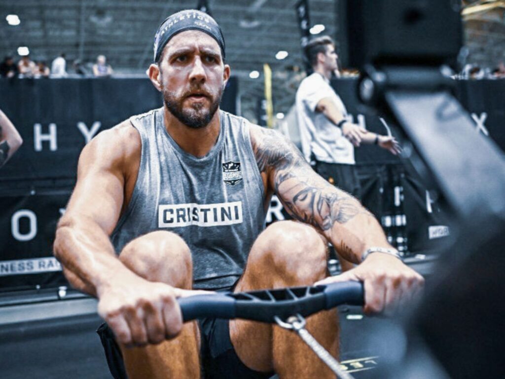 Cristini Athletics athlete pulling on a rowing machine during a HYROX race