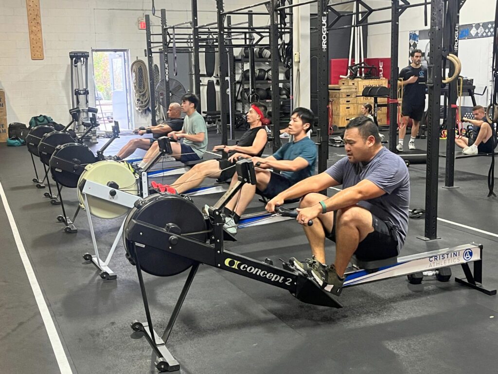 Members rowing on Concept2 rowing machines inside the Cristini Athletics gym